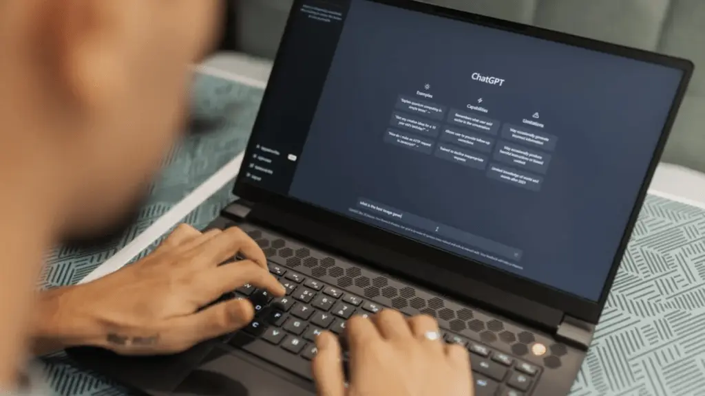 Man using chatgpt AI dark mode on laptop